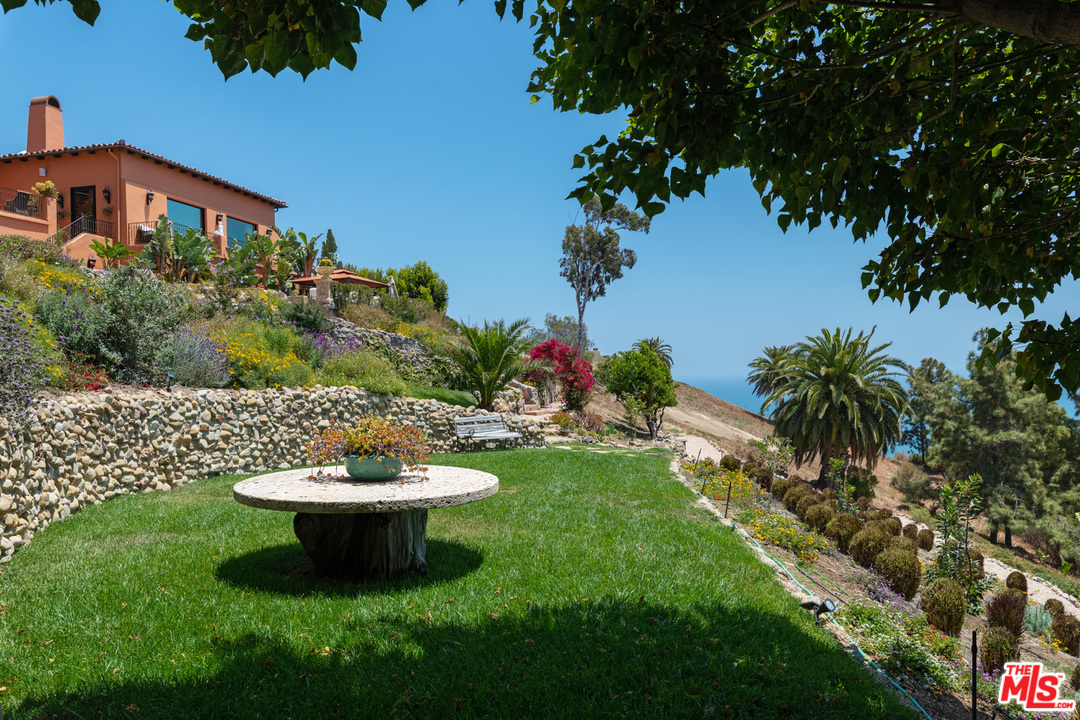 21424 Deerpath Lane Malibu, CA 90265 - Photo 46 of 51 a view of a chairs and table in the garden