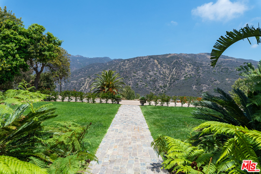 21424 Deerpath Lane Malibu, CA 90265 - Photo 49 of 51 a view of a garden with a building in the background