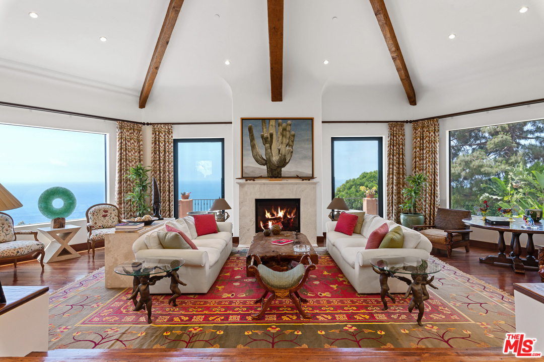 21424 Deerpath Lane Malibu, CA 90265 - Photo 7 of 51 a living room with fireplace furniture and a large window