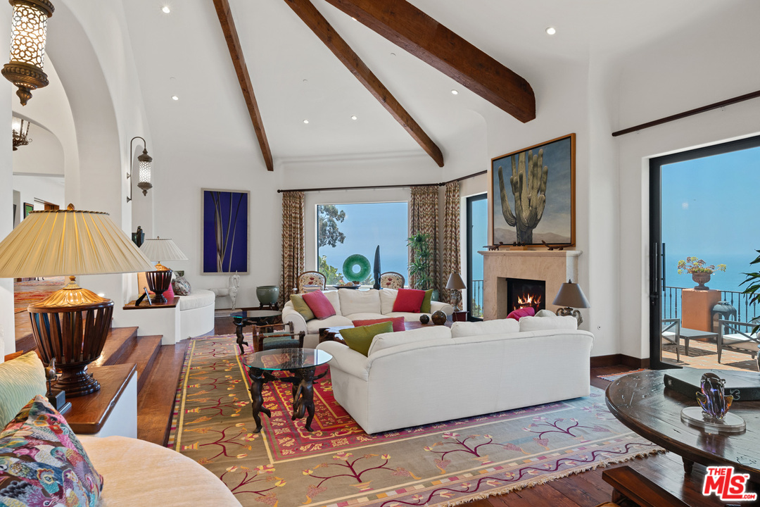 21424 Deerpath Lane Malibu, CA 90265 - Photo 10 of 51 a living room with fireplace furniture and a flat screen tv