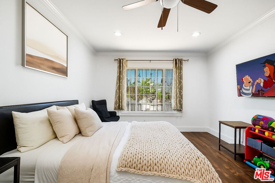 5342 Lemon Grove Avenue Los Angeles, CA 90038 - Photo 13 of 30 a bedroom with a bed and a window