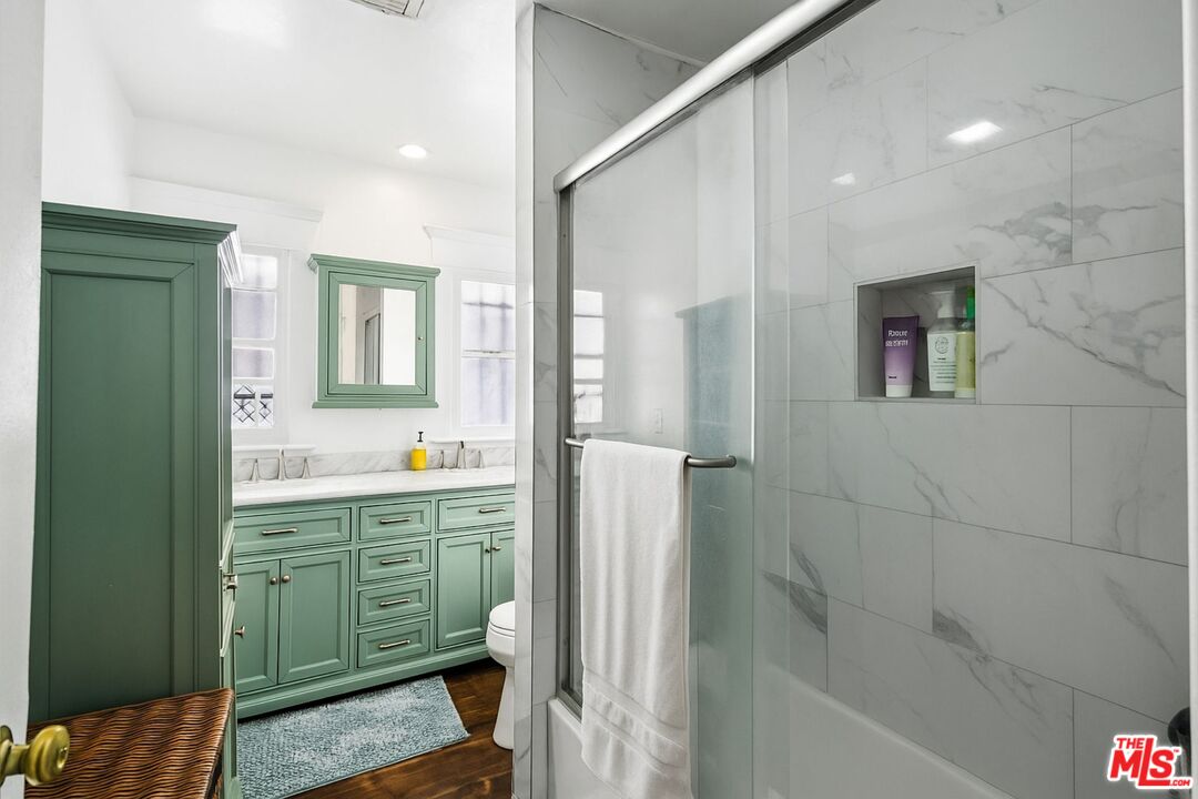 5342 Lemon Grove Avenue Los Angeles, CA 90038 - Photo 15 of 30 a bathroom with a sink mirror and a bathtub