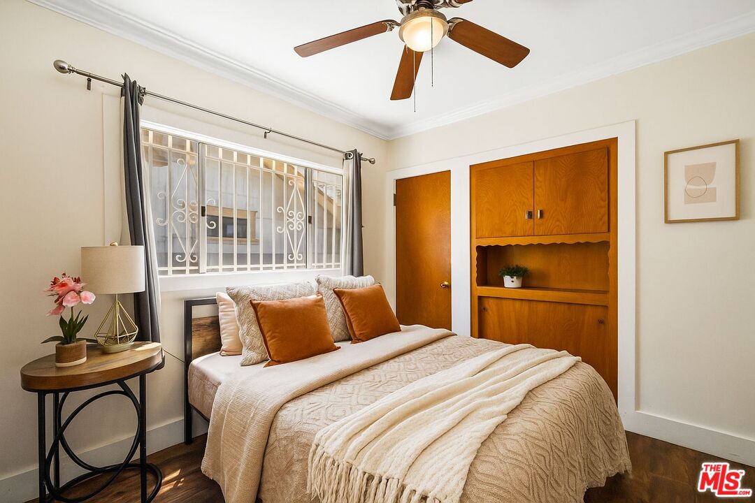 5342 Lemon Grove Avenue Los Angeles, CA 90038 - Photo 16 of 30 a bedroom with a bed and a chandelier