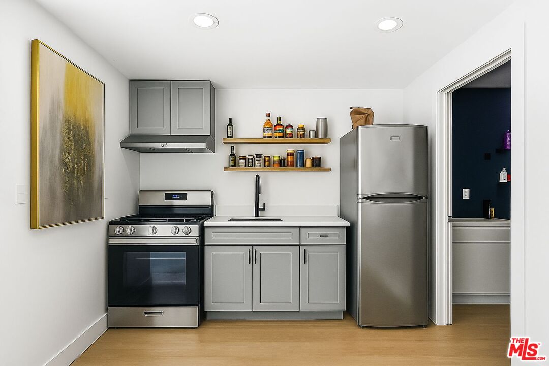 5342 Lemon Grove Avenue Los Angeles, CA 90038 - Photo 24 of 30 a kitchen with a refrigerator and a stove