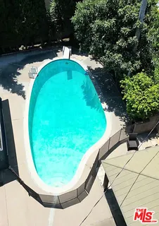 a view of swimming pool from a balcony