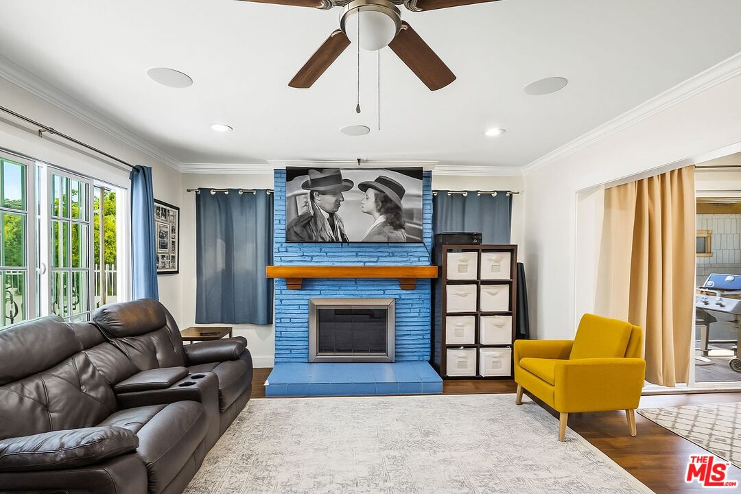 5342 Lemon Grove Avenue Los Angeles, CA 90038 - Photo 5 of 30 a living room with furniture flat screen tv and a fireplace