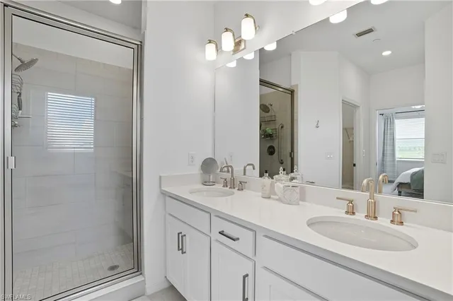 a bathroom with a double vanity sink and a mirror