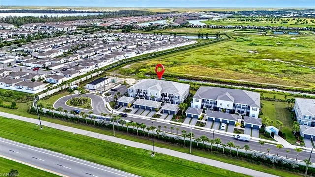 an aerial view of a house with garden space and swimming pool