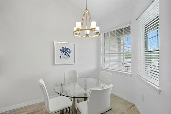 a view of a dining room with furniture wooden floor and a chandelier