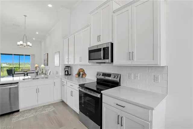 a kitchen with a sink a stove and cabinets