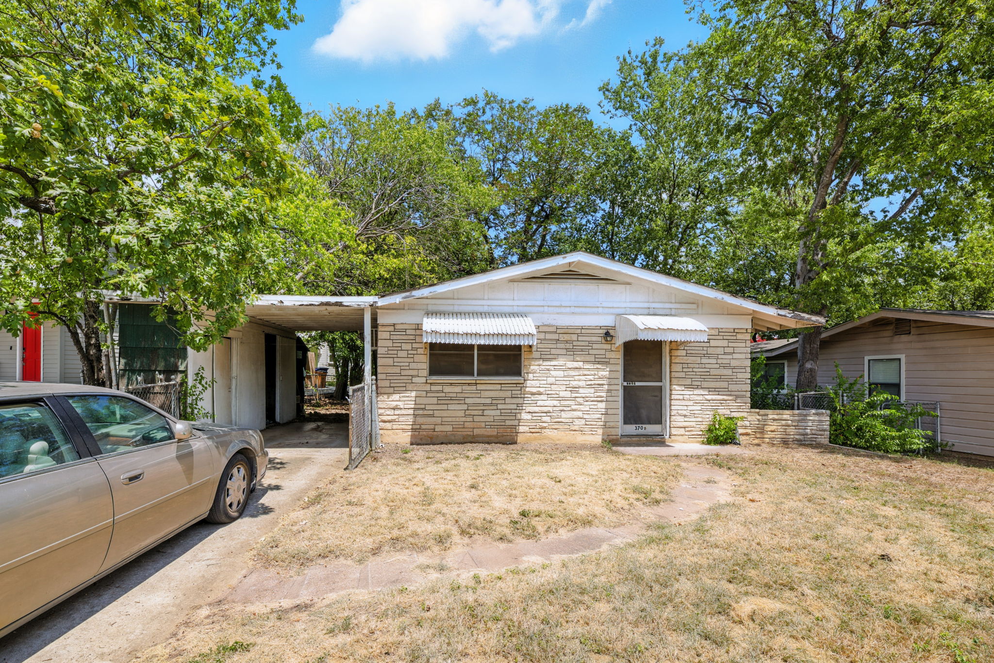 3709 Tower View Court Austin, TX 78723 - Photo 1 of 11 View of front of home with a carport, stone siding, and a front yard