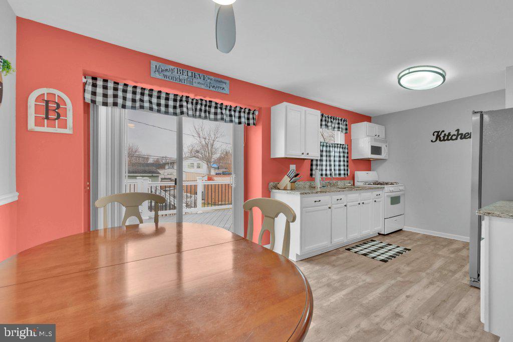 714 Joppa Farm Road Joppa, MD 21085 - Photo 16 of 46 a room with stainless steel appliances kitchen island granite countertop a stove and white cabinets