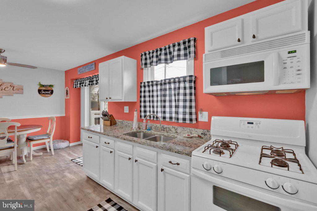 714 Joppa Farm Road Joppa, MD 21085 - Photo 19 of 46 a kitchen with stainless steel appliances granite countertop a stove a sink and a microwave