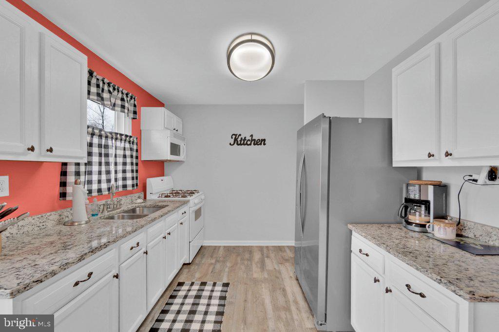714 Joppa Farm Road Joppa, MD 21085 - Photo 20 of 46 a kitchen with granite countertop a sink stove and refrigerator