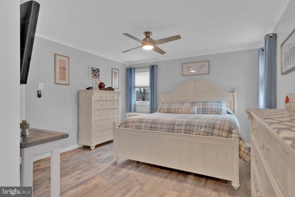 714 Joppa Farm Road Joppa, MD 21085 - Photo 24 of 46 a bedroom with a bed and a chandelier