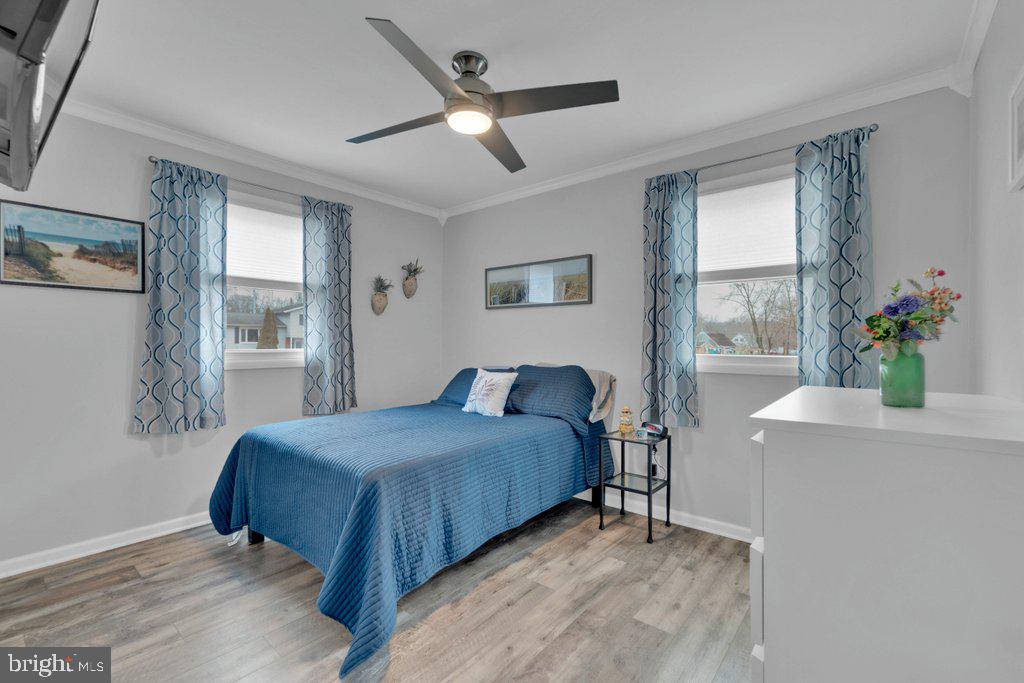 714 Joppa Farm Road Joppa, MD 21085 - Photo 29 of 46 a bedroom with a large bed chandelier and a window