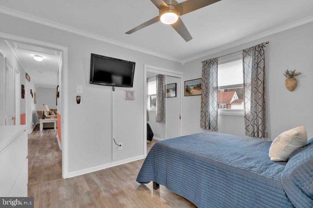 714 Joppa Farm Road Joppa, MD 21085 - Photo 30 of 46 a bedroom with a large bed a flat tv screen and a walk in closet
