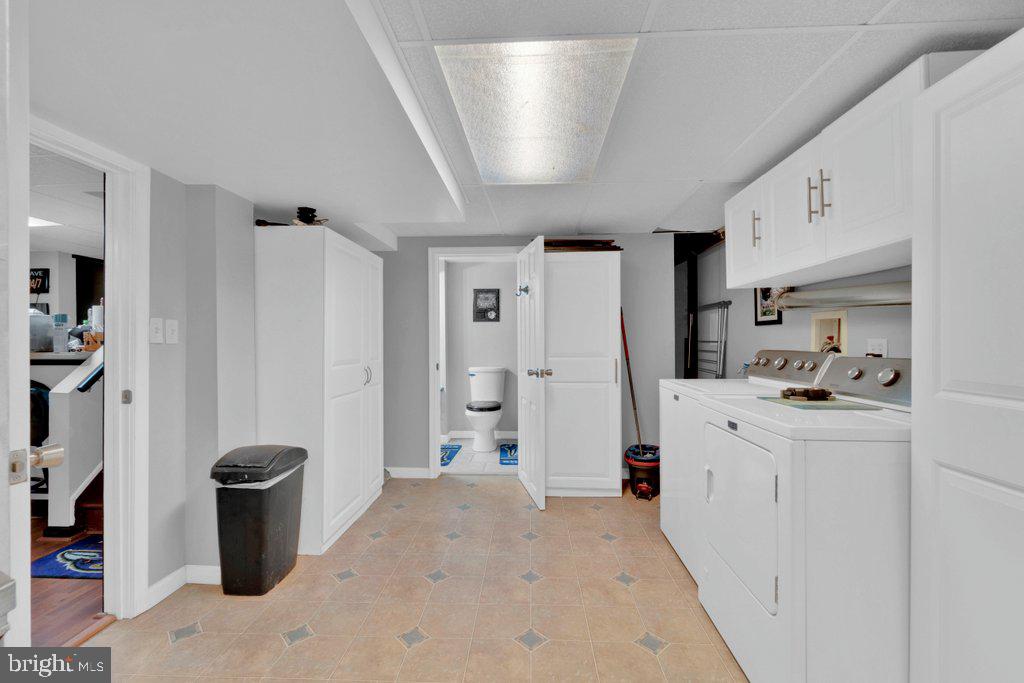 714 Joppa Farm Road Joppa, MD 21085 - Photo 43 of 46 a kitchen with stainless steel appliances a refrigerator a stove a sink dishwasher and white cabinets with wooden floor