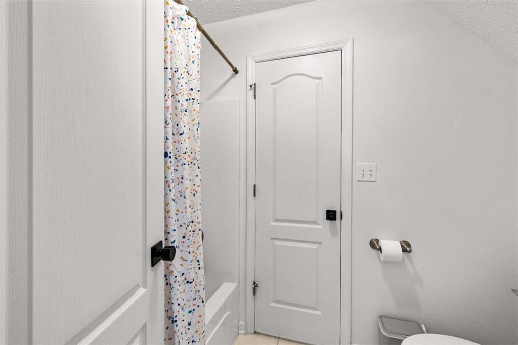 128 Byrom Road Senoia, GA 30276 - Photo 41 of 83 a bathroom with a shower curtain and a toilet