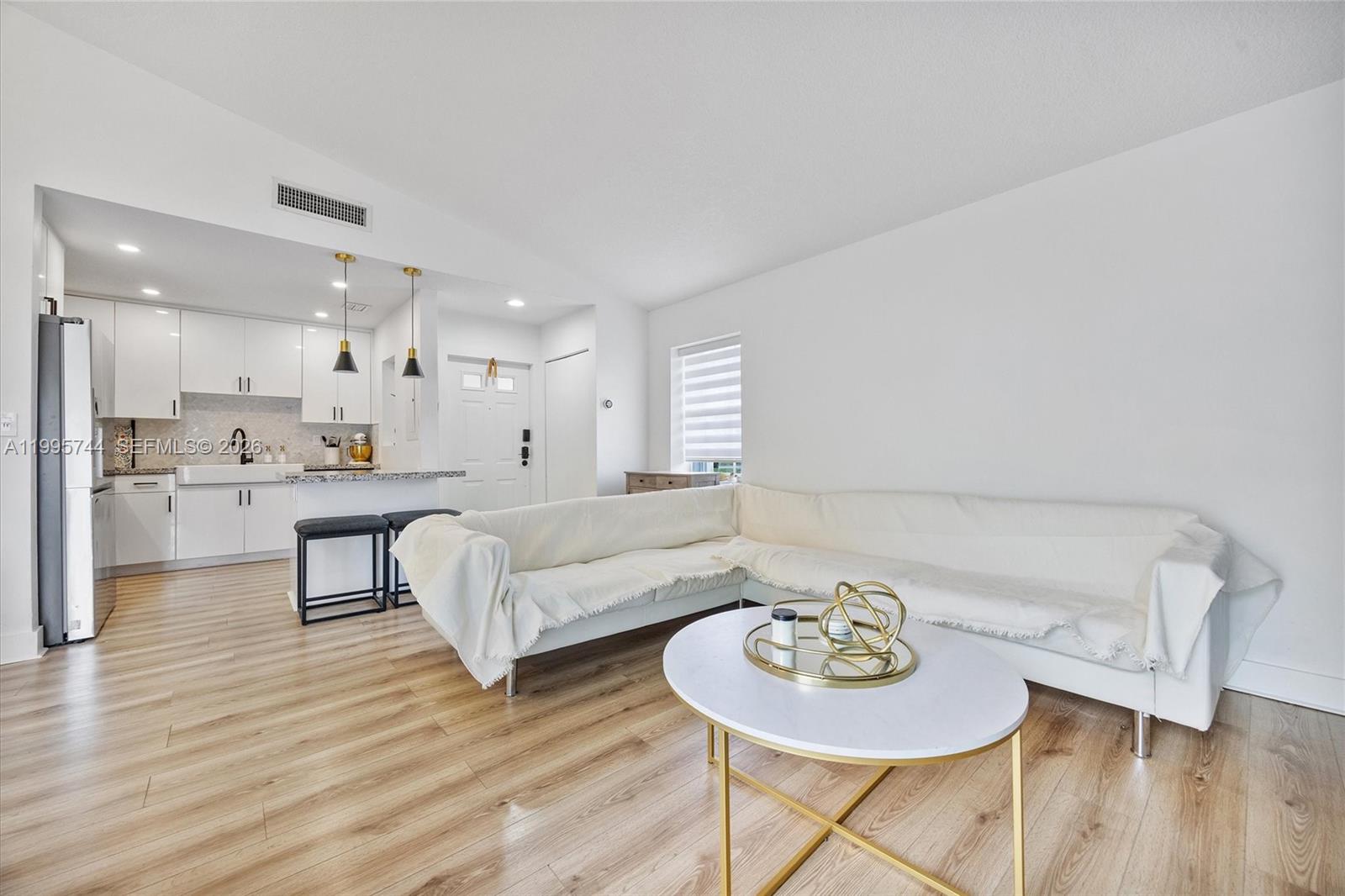 14720 Southwest 139th Avenue, Unit 139 Miami, FL 33186 - Photo 11 of 34 a living room with furniture and a kitchen view