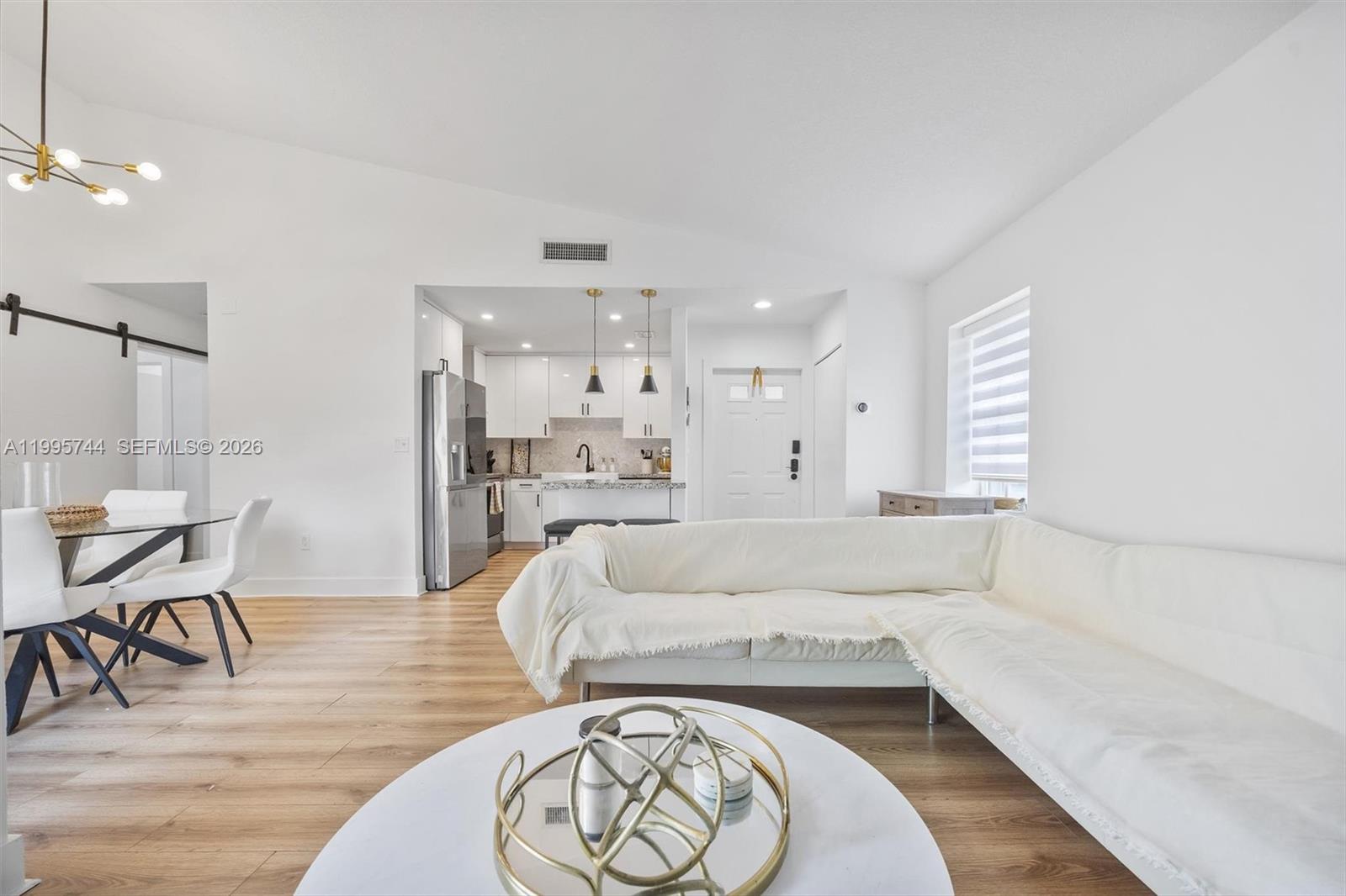 14720 Southwest 139th Avenue, Unit 139 Miami, FL 33186 - Photo 12 of 34 a living room with furniture and wooden floor
