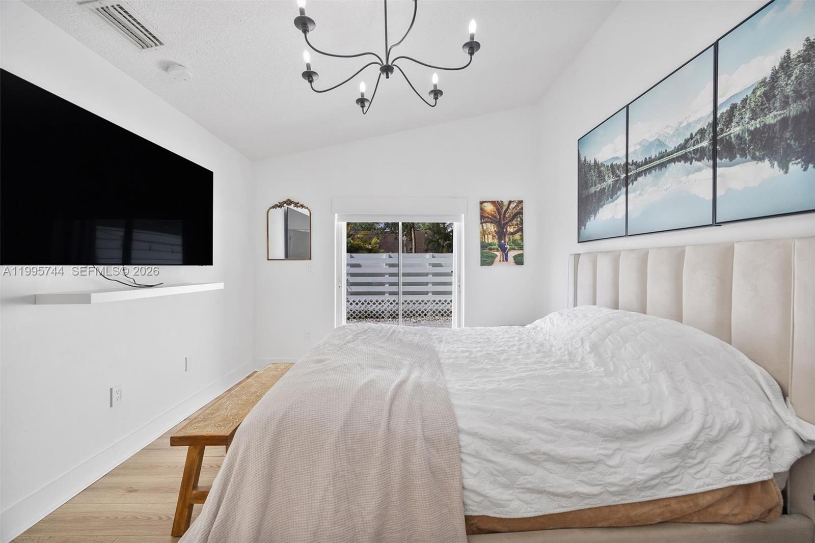 14720 Southwest 139th Avenue, Unit 139 Miami, FL 33186 - Photo 15 of 34 a bedroom with a bed and a flat screen tv