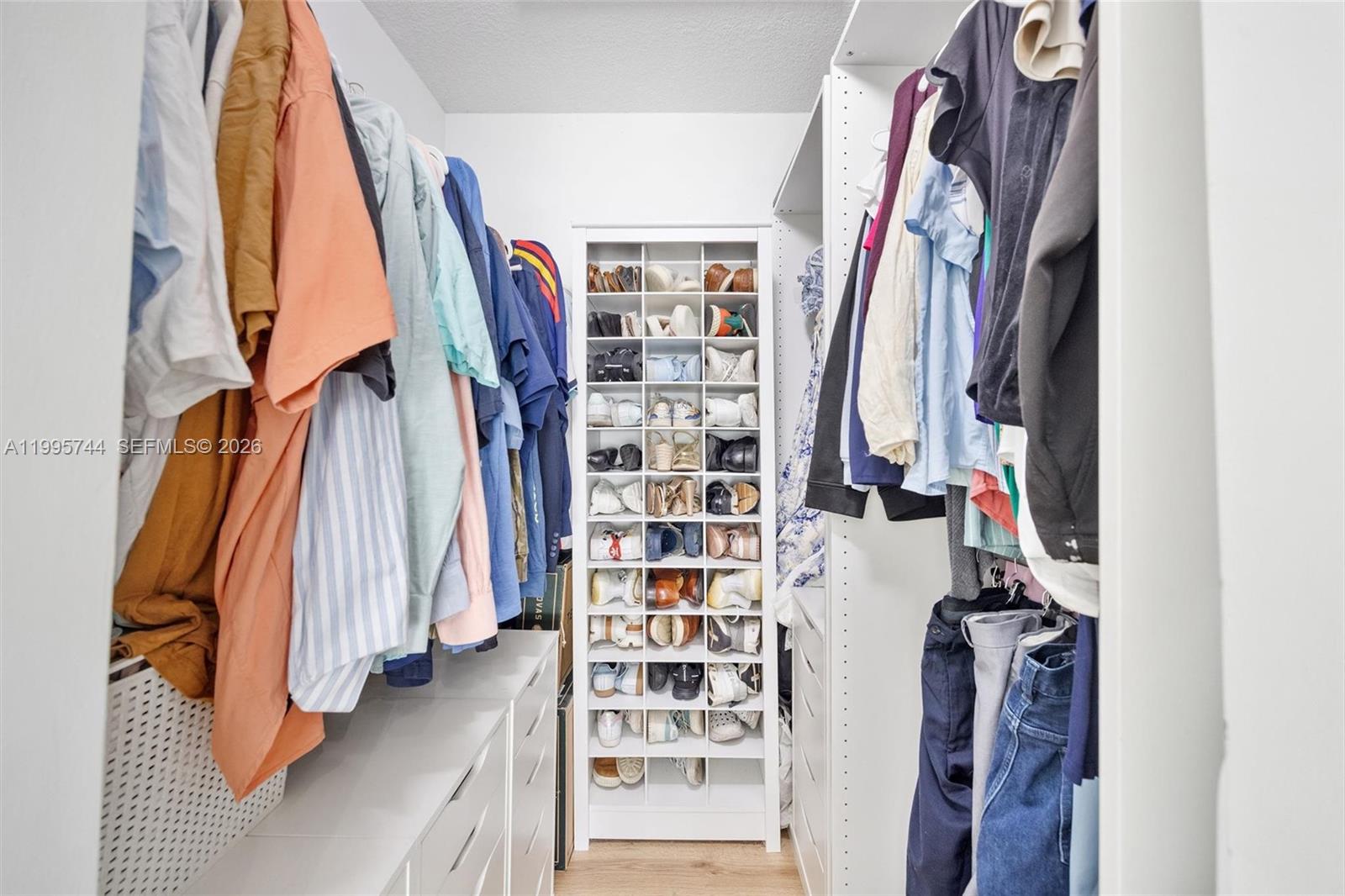14720 Southwest 139th Avenue, Unit 139 Miami, FL 33186 - Photo 17 of 34 a view of walk in closet with clothes and shoes