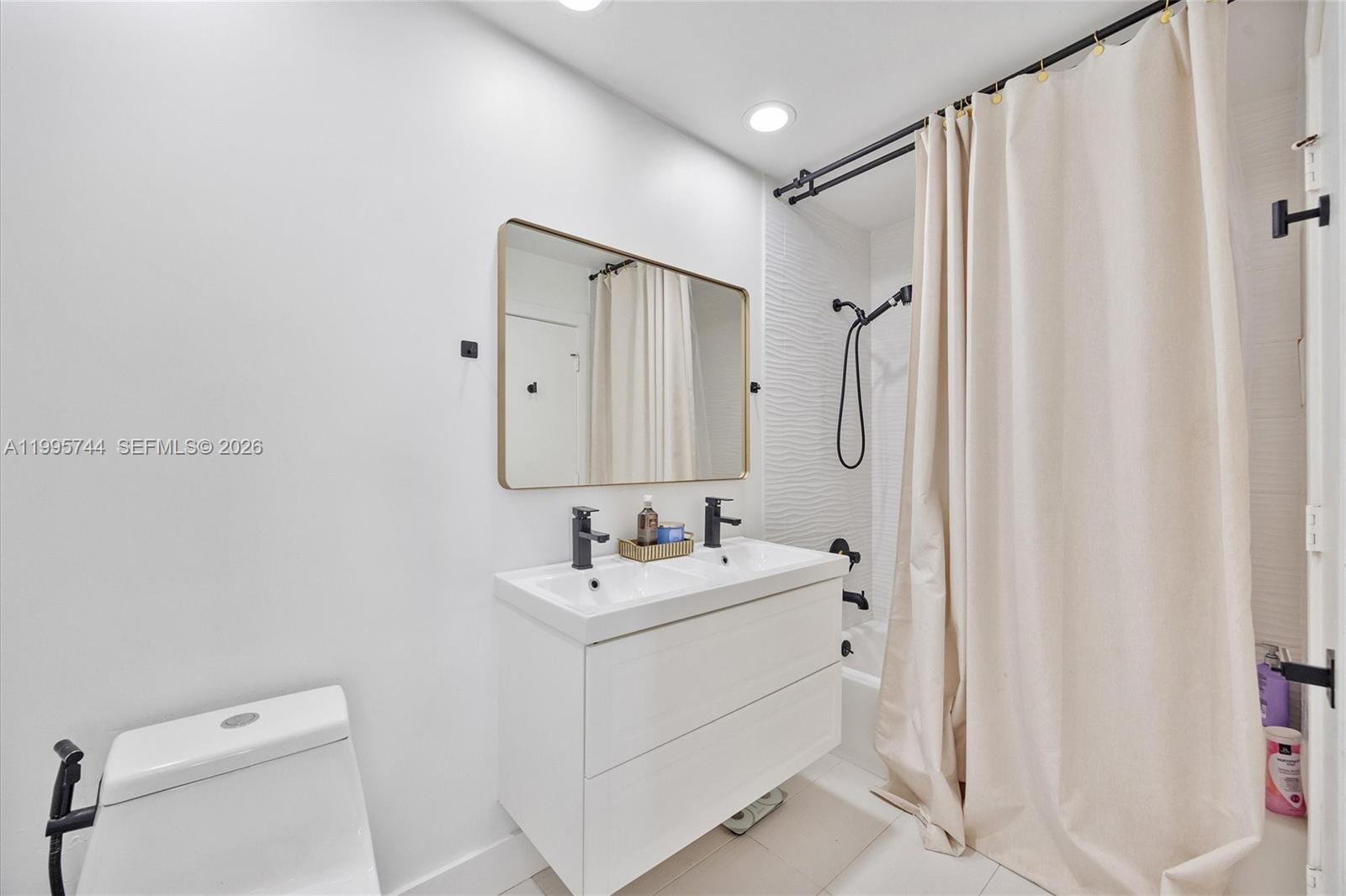 14720 Southwest 139th Avenue, Unit 139 Miami, FL 33186 - Photo 18 of 34 a bathroom with a sink a toilet and shower
