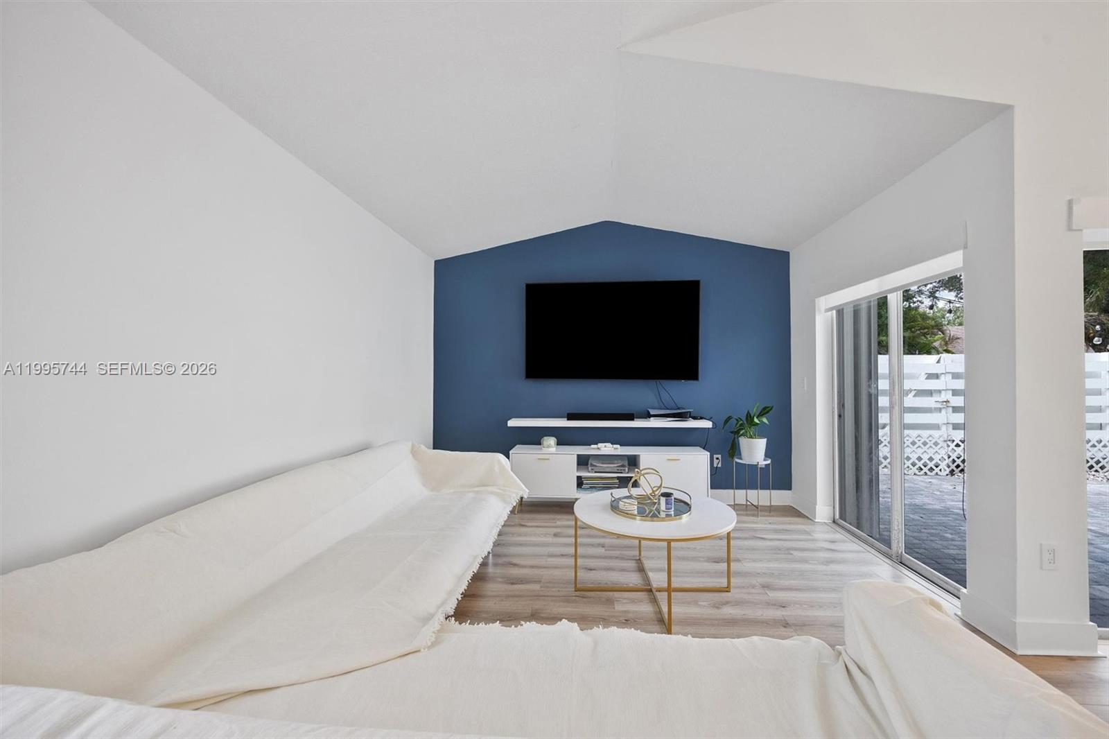 14720 Southwest 139th Avenue, Unit 139 Miami, FL 33186 - Photo 2 of 34 a living room with furniture and a flat screen tv
