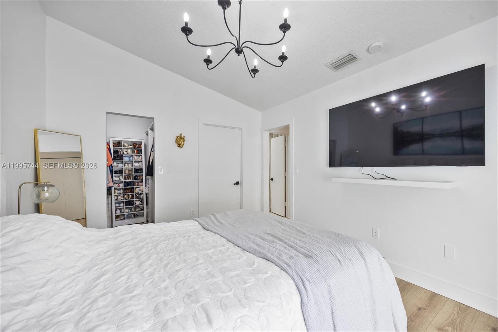 14720 Southwest 139th Avenue, Unit 139 Miami, FL 33186 - Photo 21 of 34 a bedroom with a bed and a flat screen tv