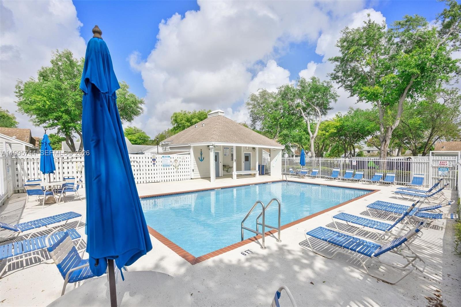 14720 Southwest 139th Avenue, Unit 139 Miami, FL 33186 - Photo 25 of 34 a view of a swimming pool with a patio
