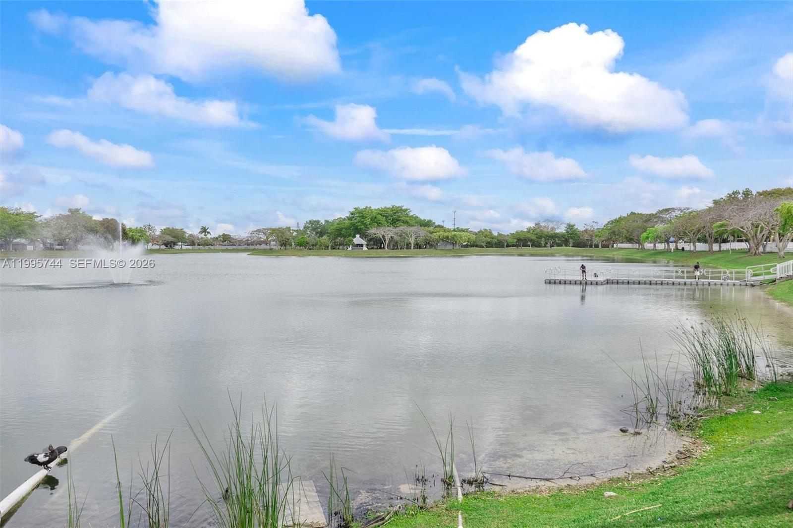 14720 Southwest 139th Avenue, Unit 139 Miami, FL 33186 - Photo 26 of 34 a view of a lake with houses in the back