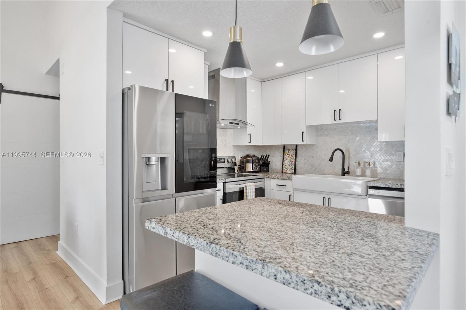 14720 Southwest 139th Avenue, Unit 139 Miami, FL 33186 - Photo 3 of 34 a kitchen with stainless steel appliances granite countertop a sink refrigerator and cabinets
