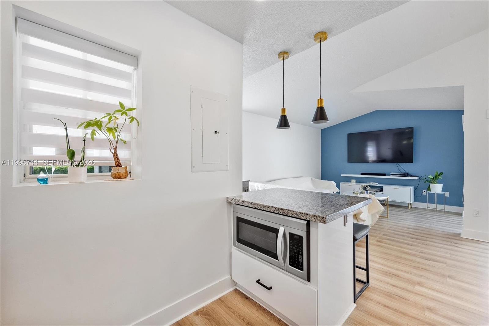 14720 Southwest 139th Avenue, Unit 139 Miami, FL 33186 - Photo 5 of 34 a kitchen with stainless steel appliances white cabinets and wooden floor