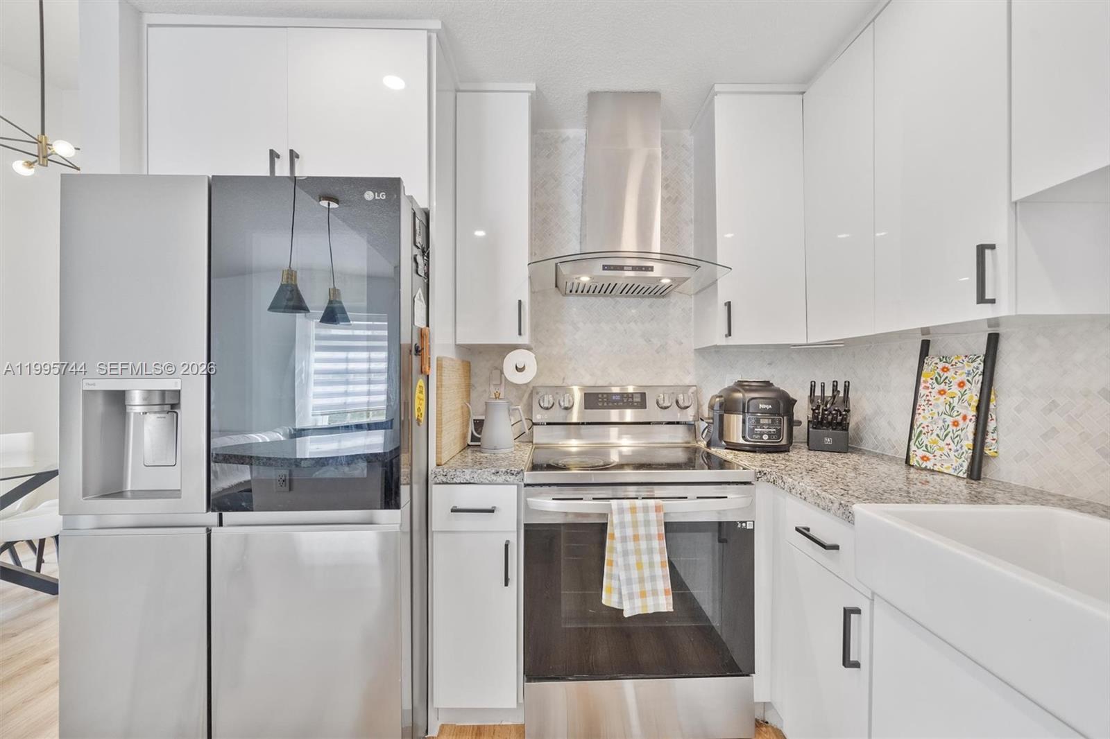 14720 Southwest 139th Avenue, Unit 139 Miami, FL 33186 - Photo 6 of 34 a kitchen with stainless steel appliances granite countertop a refrigerator a stove and a sink