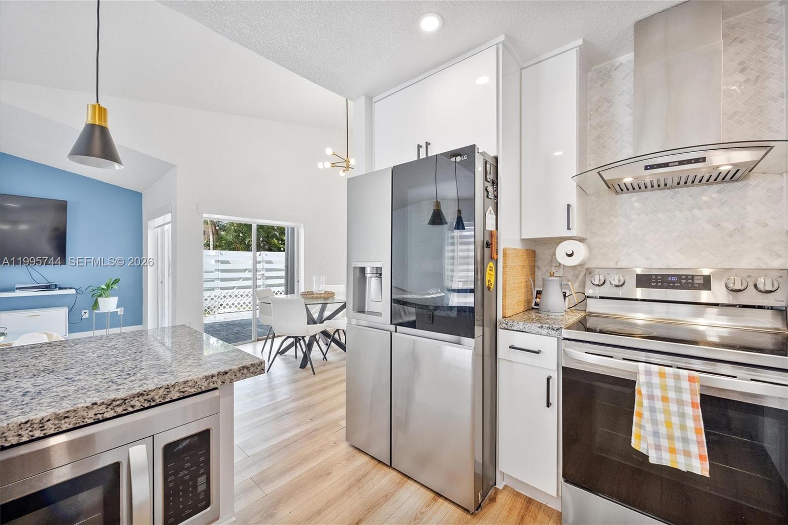 14720 Southwest 139th Avenue, Unit 139 Miami, FL 33186 - Photo 7 of 34 a kitchen with cabinets and stainless steel appliances