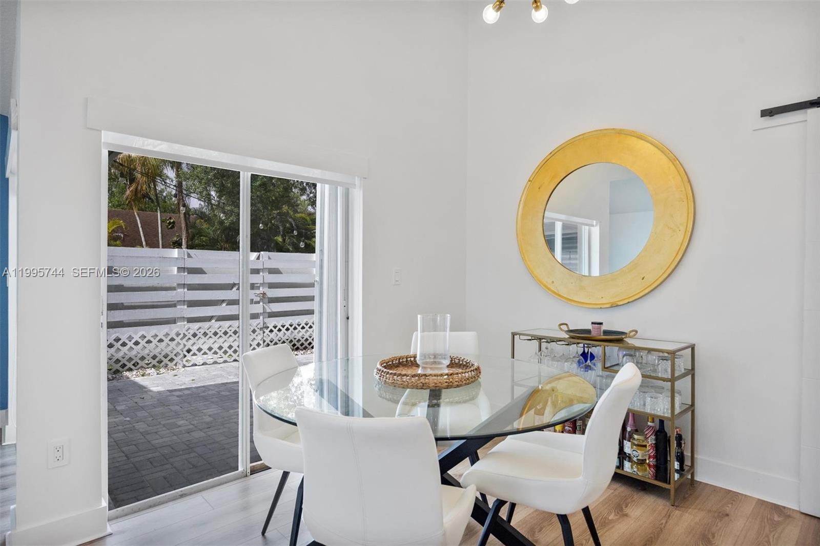 14720 Southwest 139th Avenue, Unit 139 Miami, FL 33186 - Photo 8 of 34 a view of a dining room with furniture a chandelier and wooden floor
