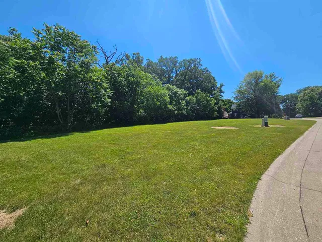 a view of a golf course with a house in the background