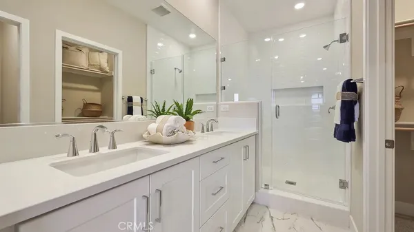 a bathroom with a shower sink and mirror
