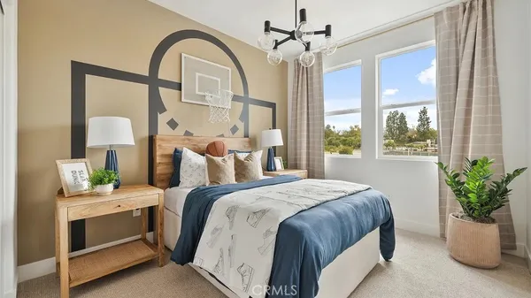 a bedroom with a bed and a potted plant
