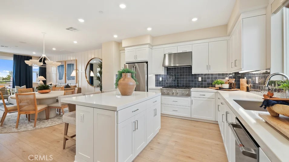1835 Lychee Street Fullerton, CA 92833 - Photo 2 of 20 a kitchen with a sink white cabinets and stainless steel appliances