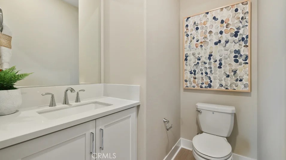 1835 Lychee Street Fullerton, CA 92833 - Photo 8 of 20 a bathroom with a toilet sink and mirror