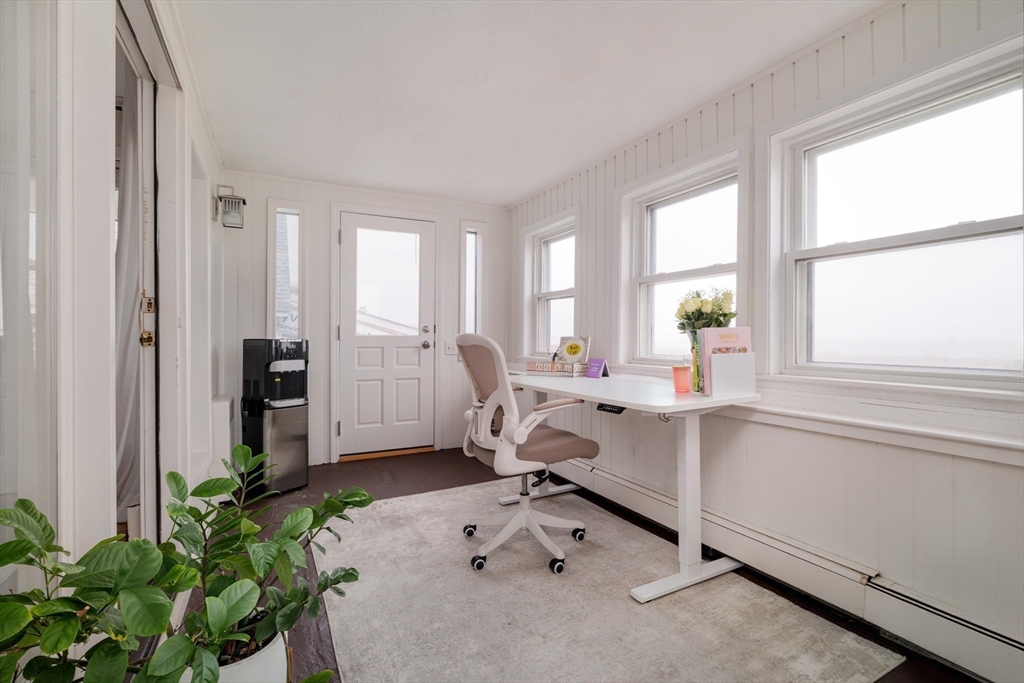 129 The Strand Winthrop, MA 02152 - Photo 29 of 42 a room with window table and chairs in it