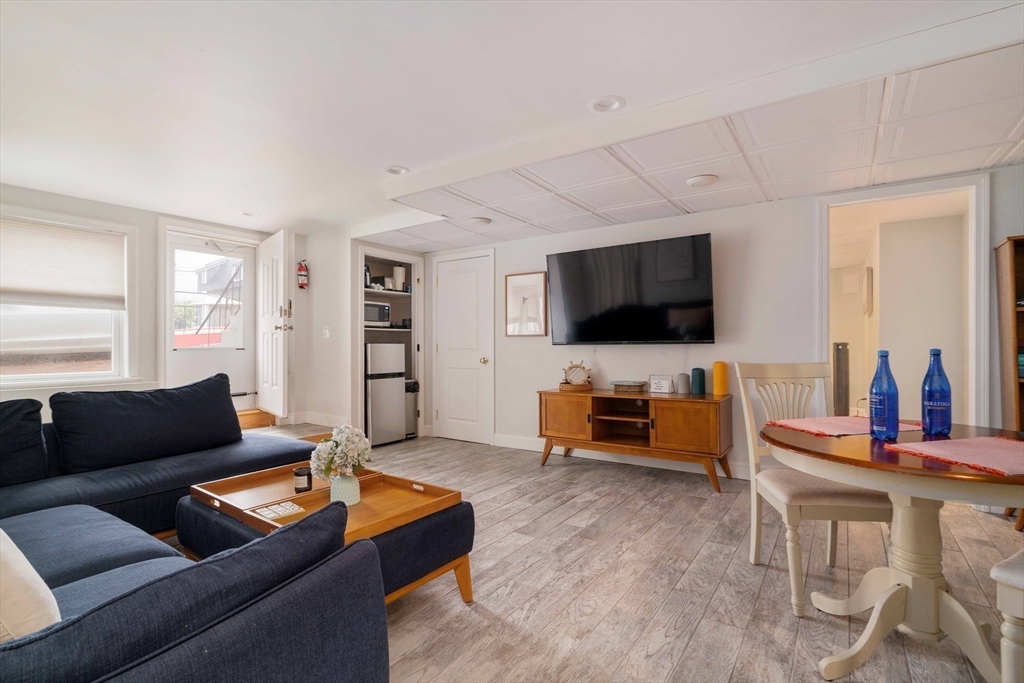 129 The Strand Winthrop, MA 02152 - Photo 32 of 42 a living room with furniture and a flat screen tv