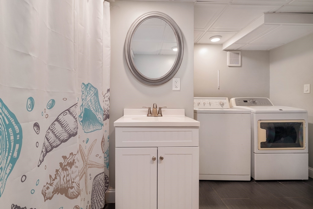 129 The Strand Winthrop, MA 02152 - Photo 35 of 42 a bathroom with a sink and a mirror