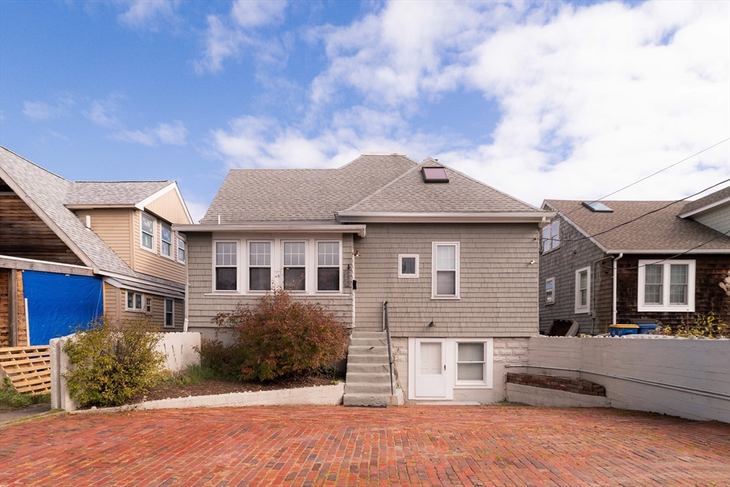 129 The Strand Winthrop, MA 02152 - Photo 39 of 42 a front view of a house with a yard