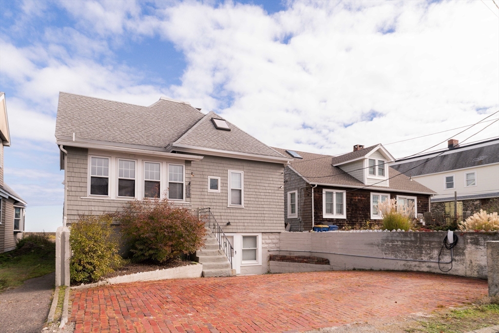 129 The Strand Winthrop, MA 02152 - Photo 40 of 42 a front view of a house with a yard