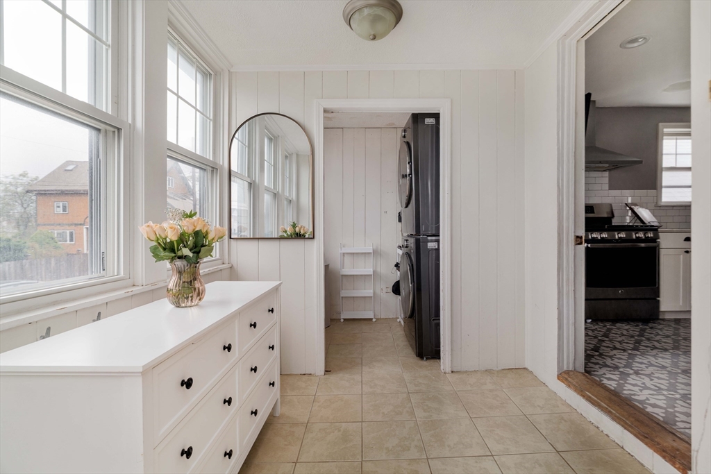 129 The Strand Winthrop, MA 02152 - Photo 4 of 42 a bathroom with a double vanity sink a mirror and a shower