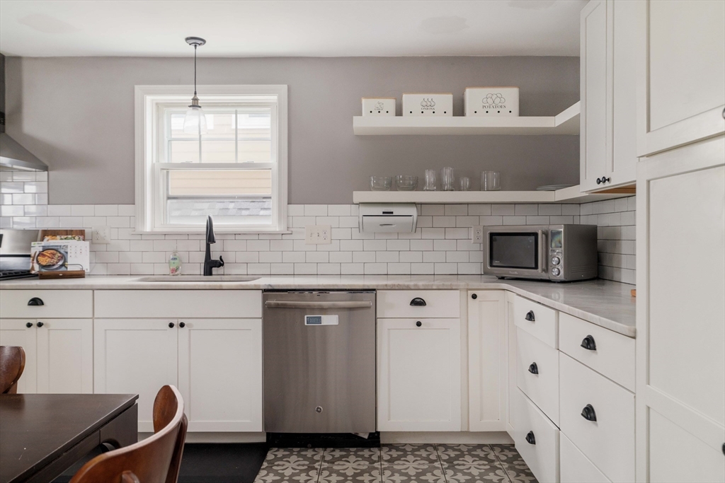 129 The Strand Winthrop, MA 02152 - Photo 7 of 42 a kitchen with appliances cabinets and a sink