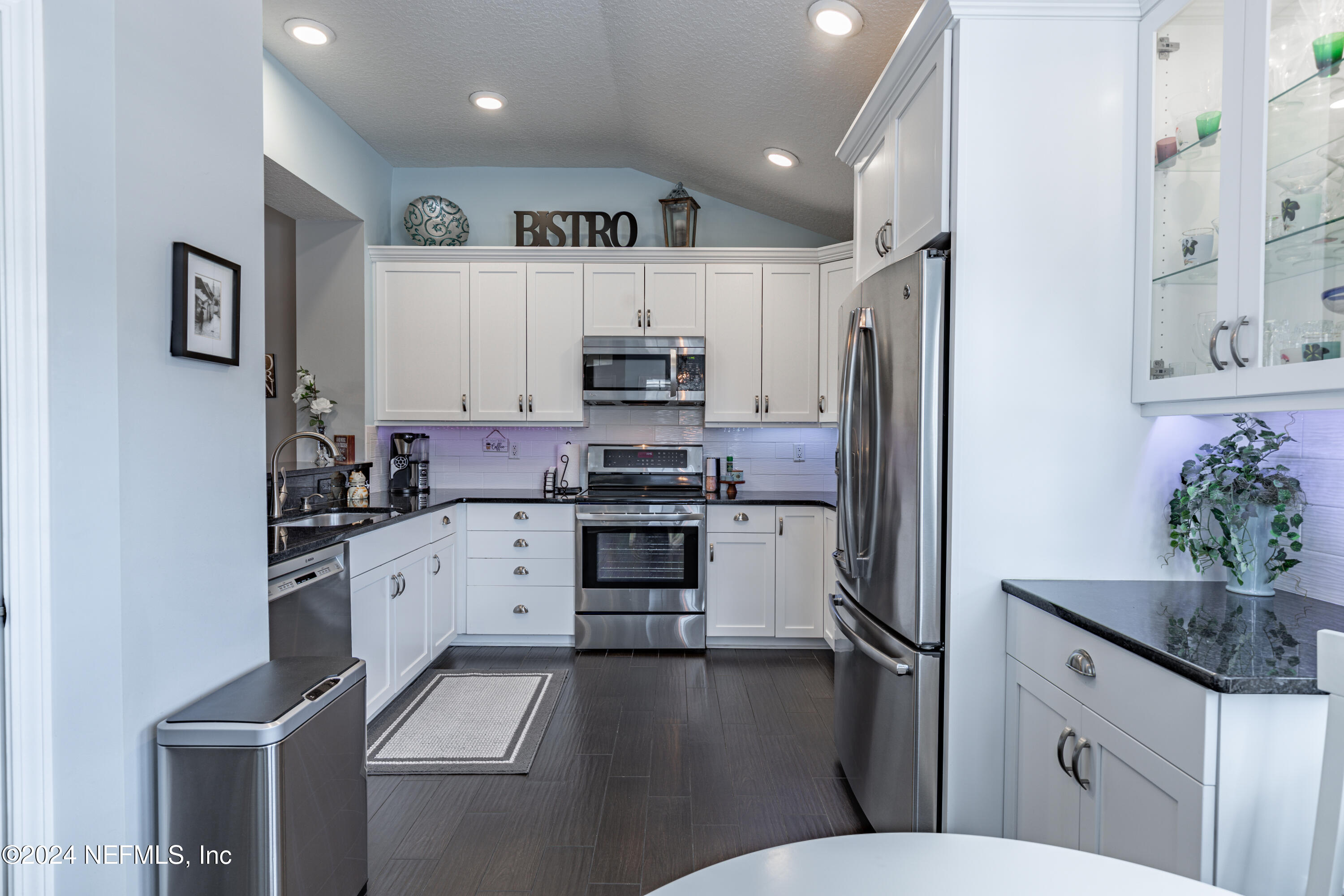 1830 Copper Stone Drive, Unit D Fleming Island, FL 32003 - Photo 12 of 65 a kitchen with stainless steel appliances a refrigerator sink and microwave